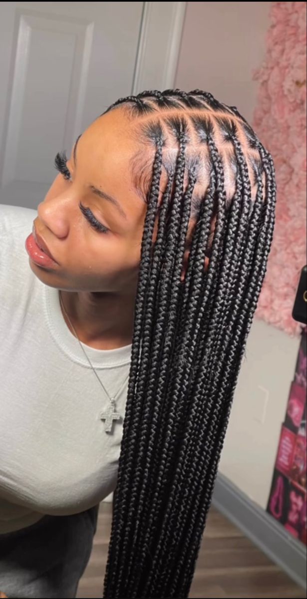 Clean parted knotless braids styled at Stella Braids and Hair Studio in Covina